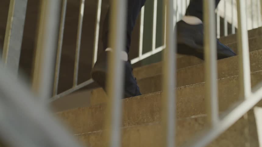 Man runs up stairs during daylight