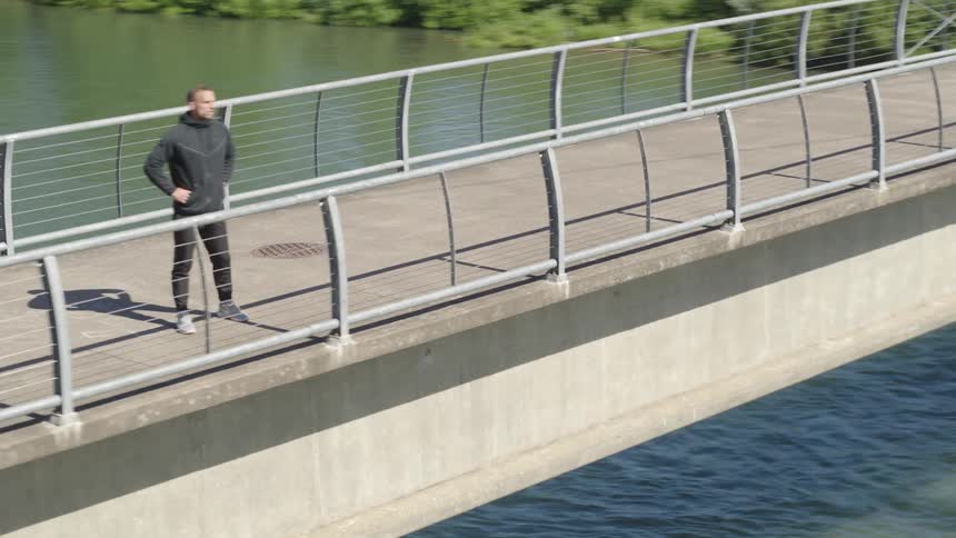 A man looking out towards a river