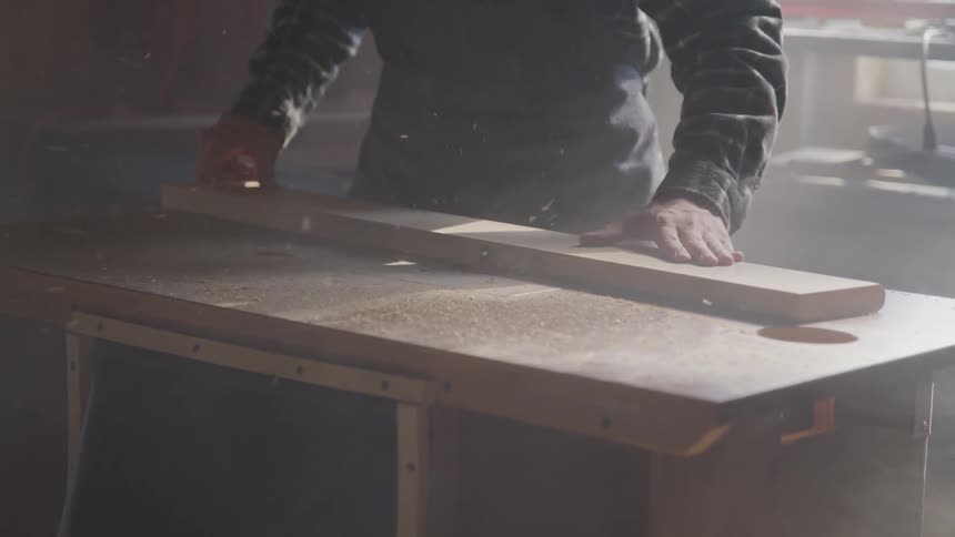 Man sawing a board