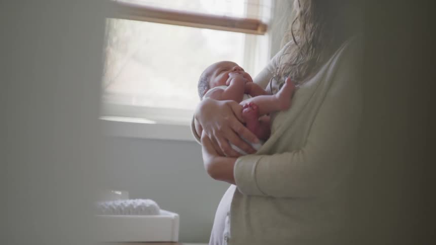 New mother rocking her baby