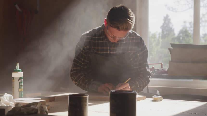 A carpenter doing carpentry at his workshop