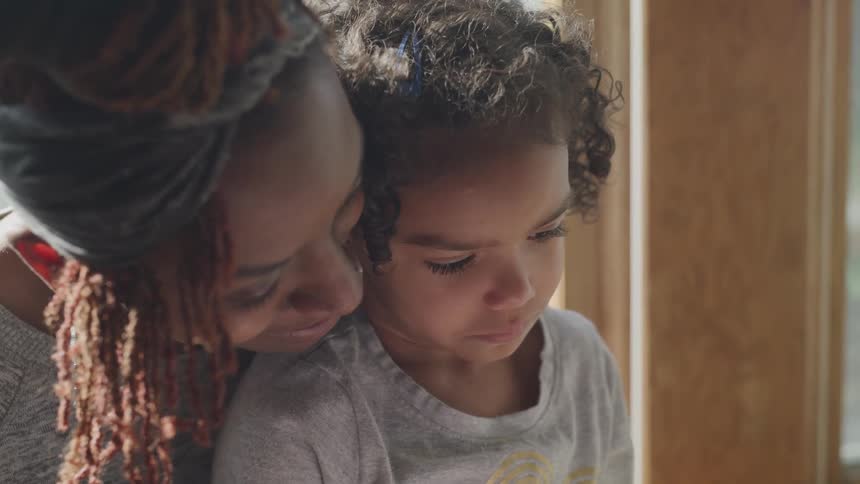 Girl reading to her son