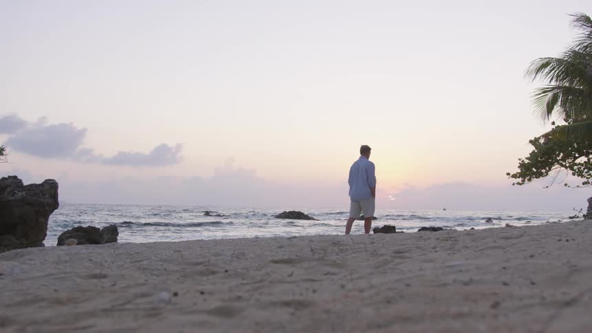 A man walks on the beach