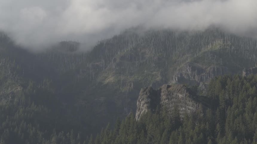 The clouds are rolling over the mountain