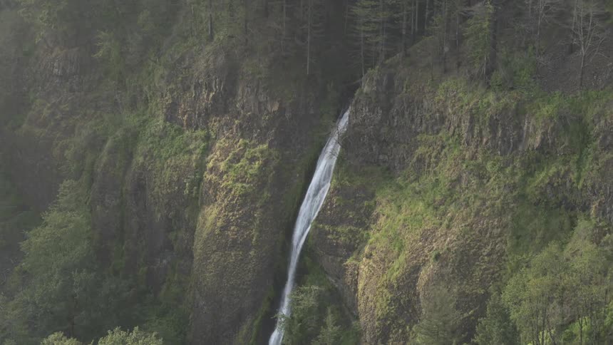 A waterfall cascades down a hillside