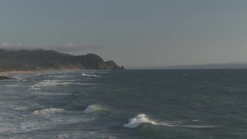 Waves washing into a coastline during the day