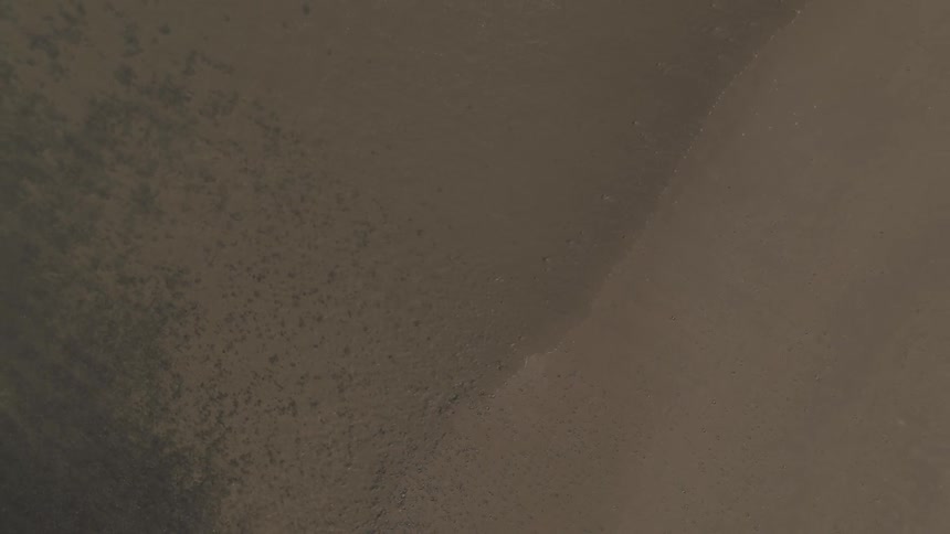 Surf washes up onto beach