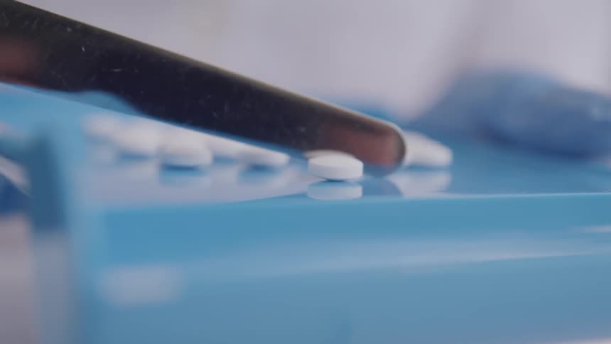 A pharmacist counts pills