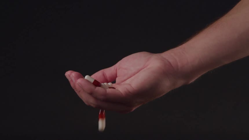 A hand catches medication