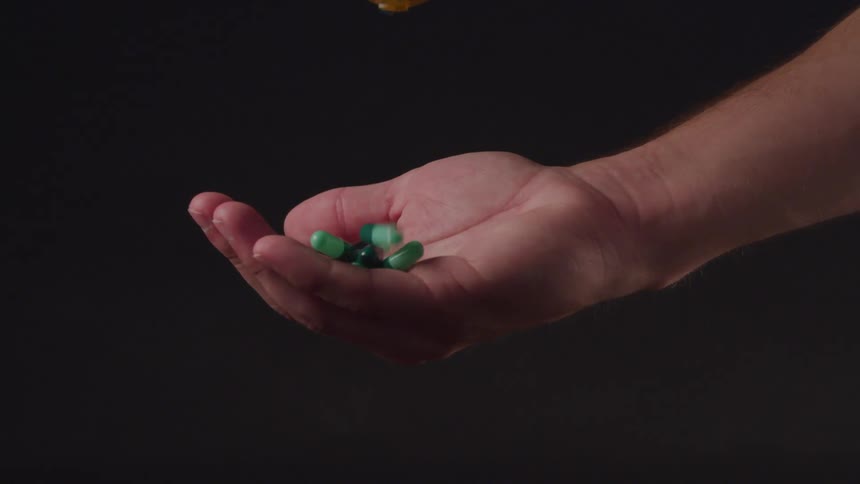 Dropping pills into a hand