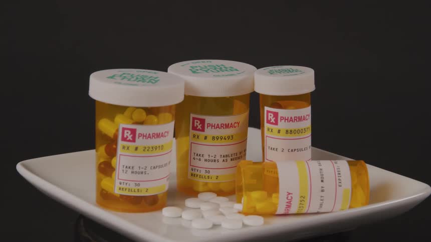 Bottles of pills are displayed on a plate