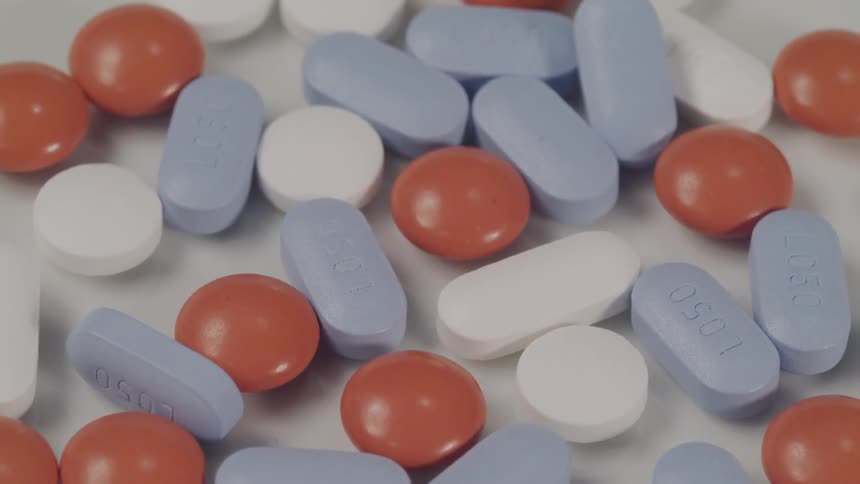 Red white and blue pills on a table