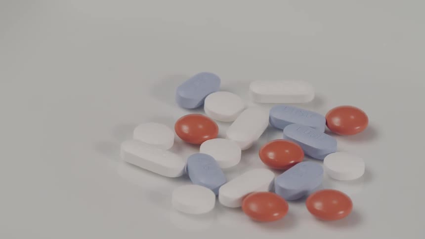 Red white and blue pills on a table