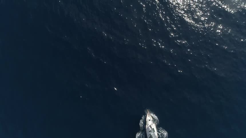 Boat sails through ocean causing a wake