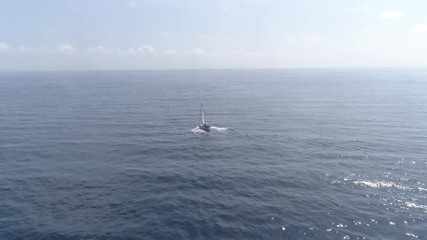 View of boat in the ocean from behind