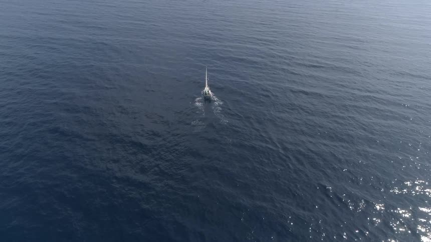 A sailing boat sailing in the wide ocean