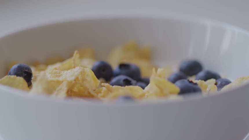 Bowl of cornflakes and blueberries in milk