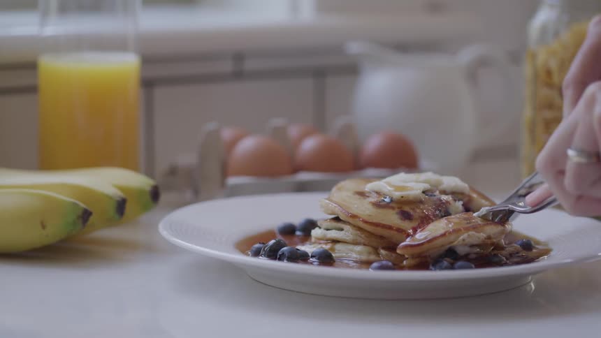Person cutting pancakes
