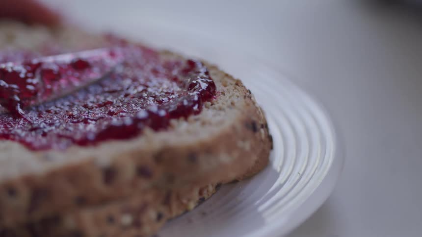 Jelly is spread across bread