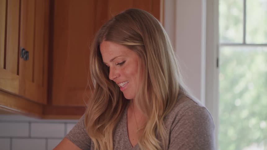 Blonde woman cooks in the kitchen during daylight