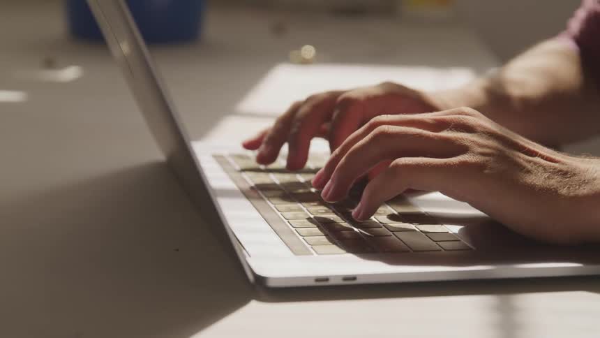 Male typing on a computer