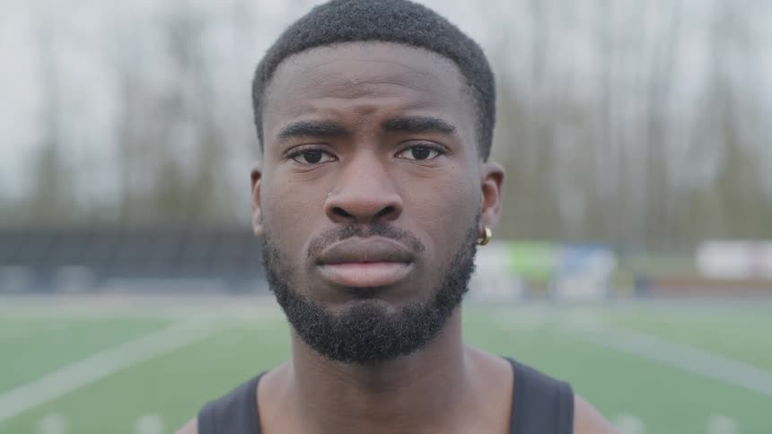 A man stands on a football field