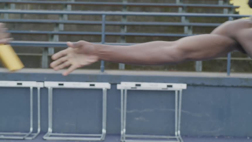 Men doing relay at the athletics field