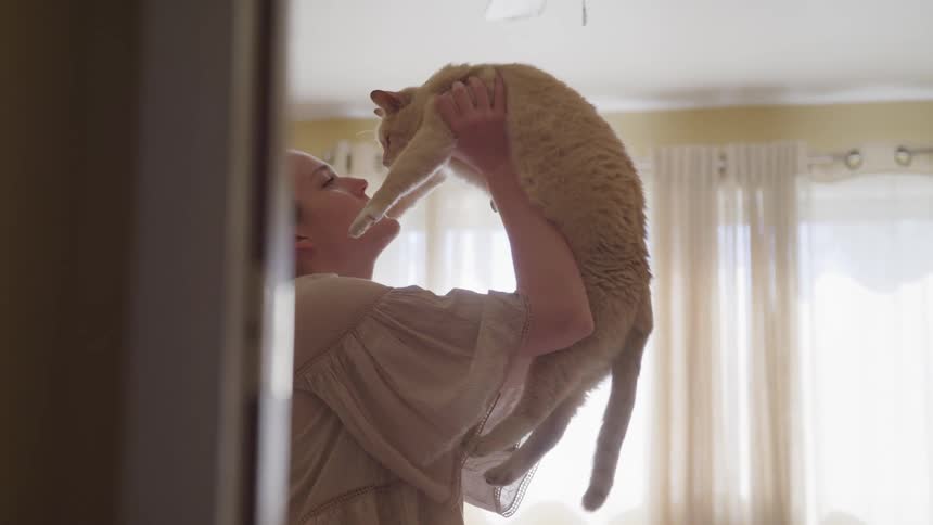 Girl picking up her cat
