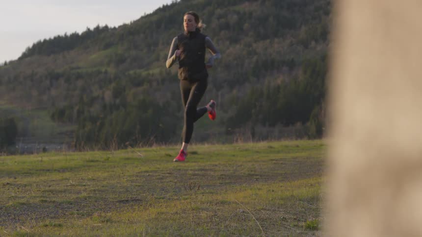 A woman runs across a field