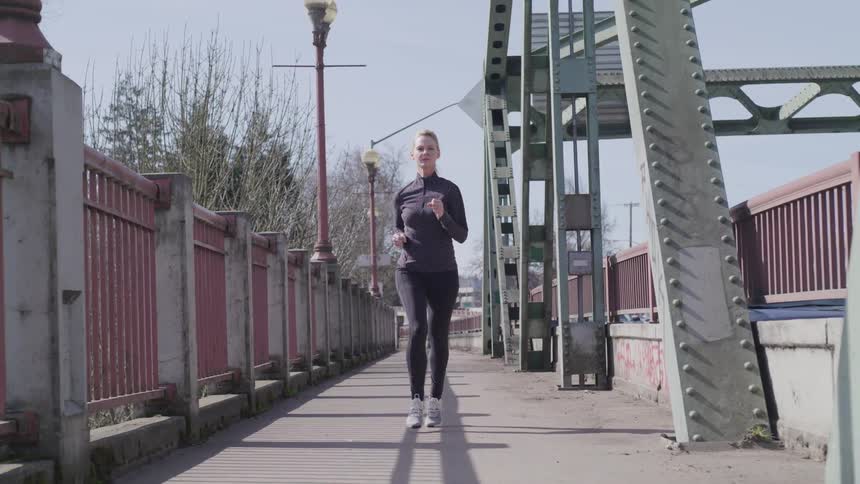 Girl running across the bridge