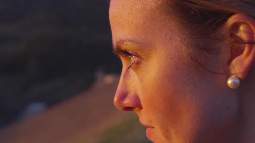Woman contemplating under yellow colored light