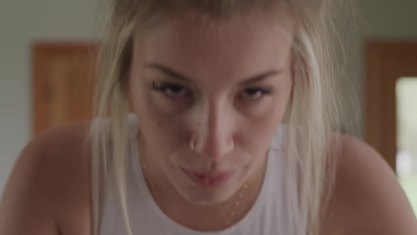 A woman breathes deeply while exercising