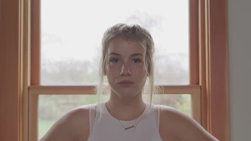 Girl standing in front of a window