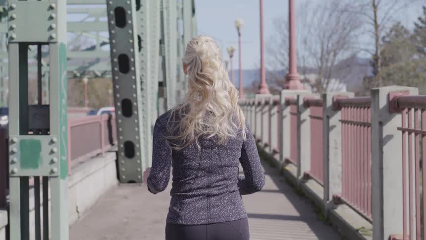 Girl running on a bridge