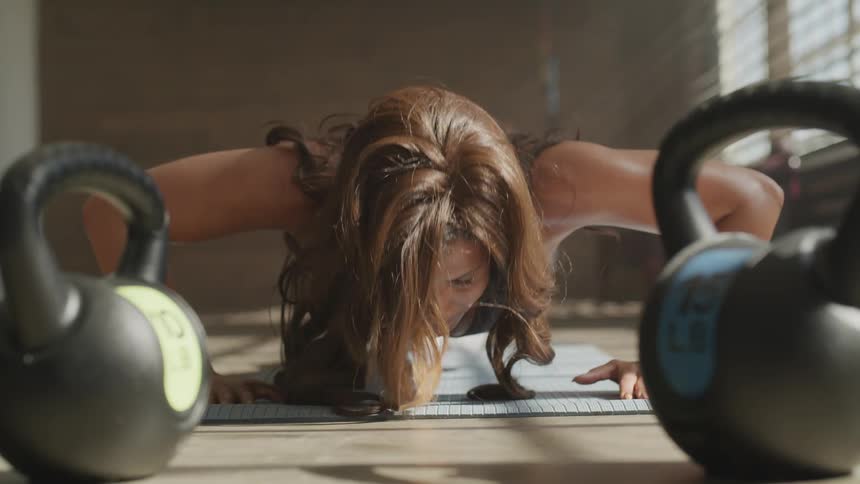 A woman inside on a map doing push ups