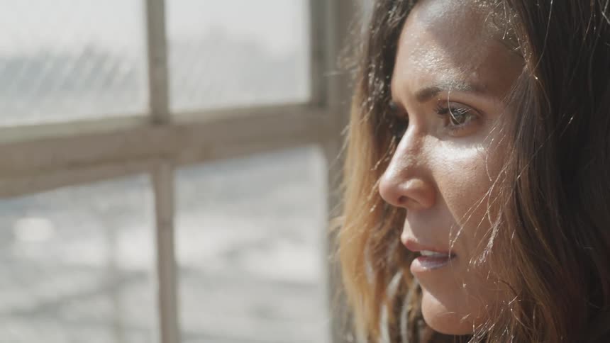 Woman looks through the window