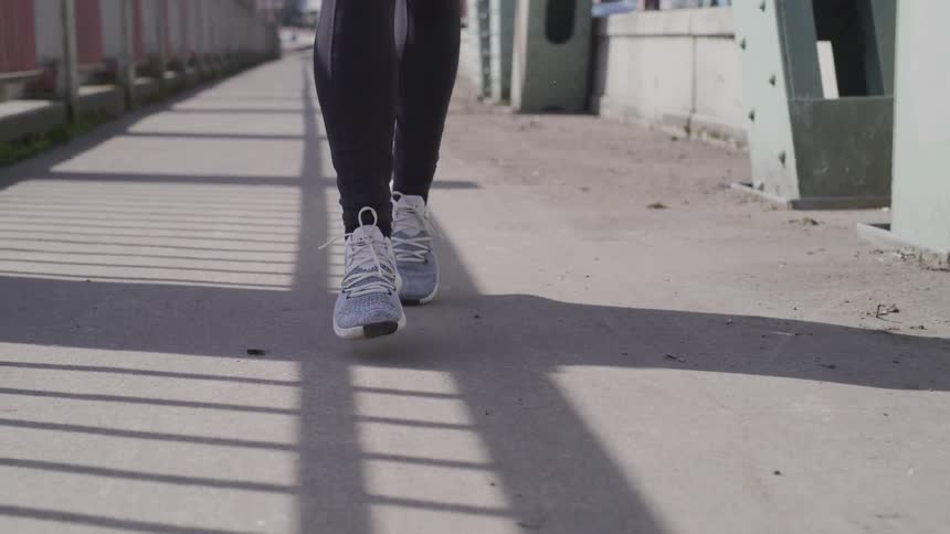 Person running on a bridge