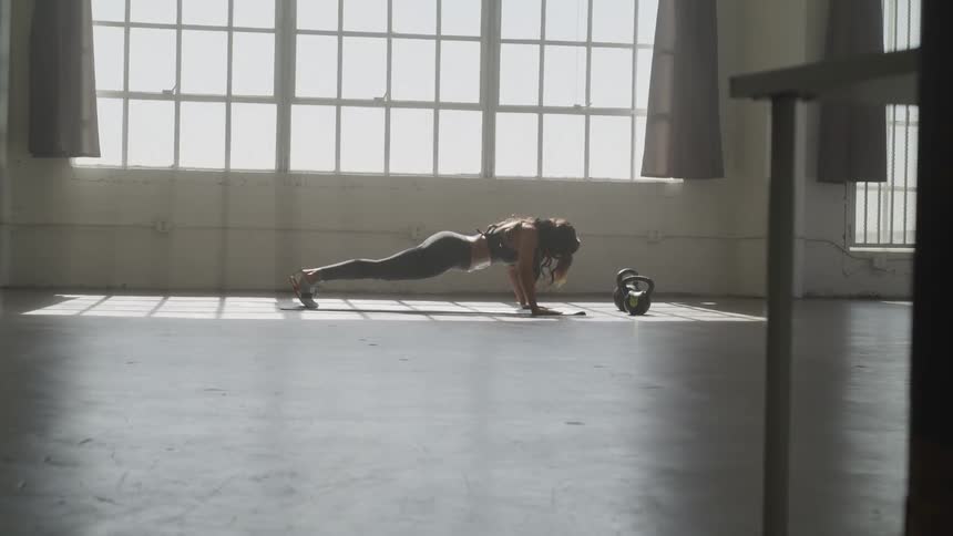 A middle age woman exercising in a building