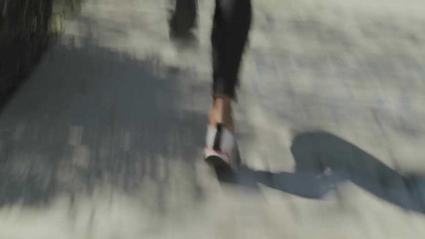 Girl running down a side walk