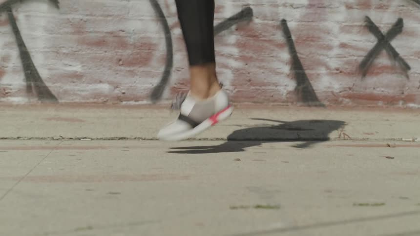 Woman is jump roping outdoors