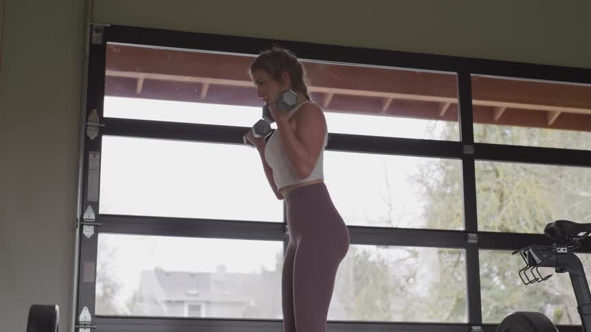 Girl curing dumbbells