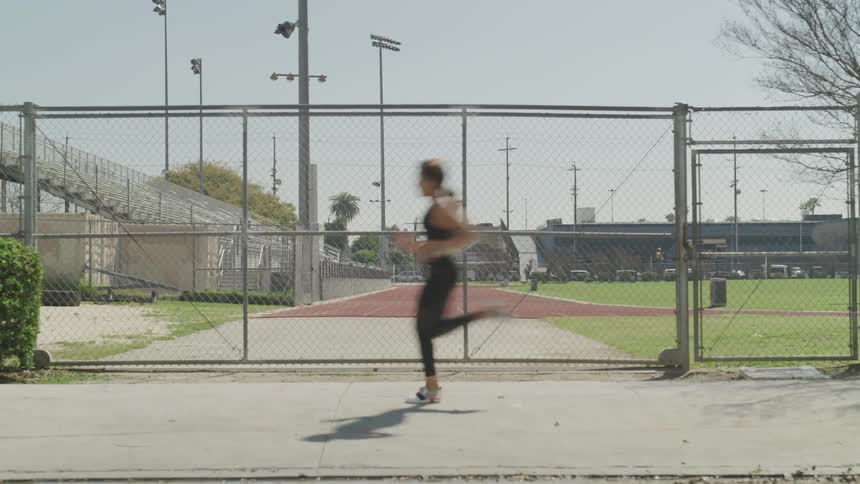 A woman running on a sidewalk