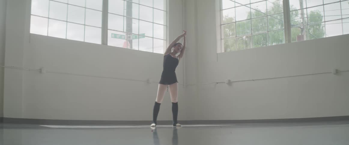 A dancer stretches side to side