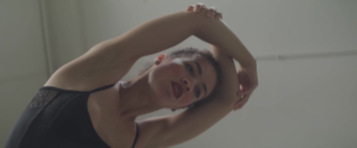 A dancer stretches and warms up