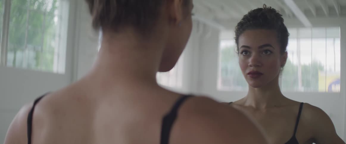 Ballerina standing in front of a mirror