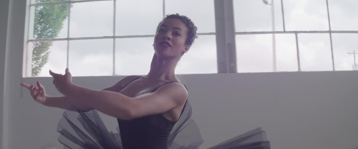 A woman dances in a ballet studio
