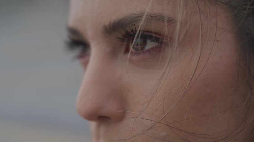 A woman fixes her eyes to something in the distance