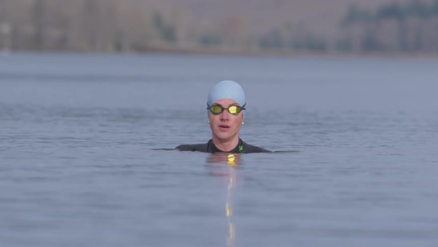 A woman is in a lake swimming