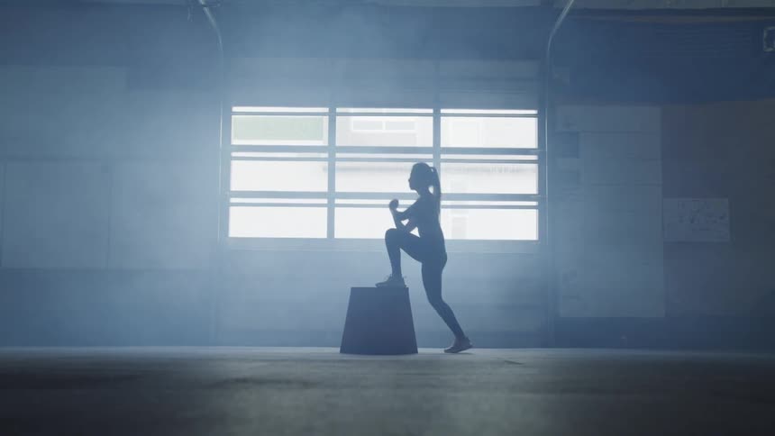 A woman does step ups