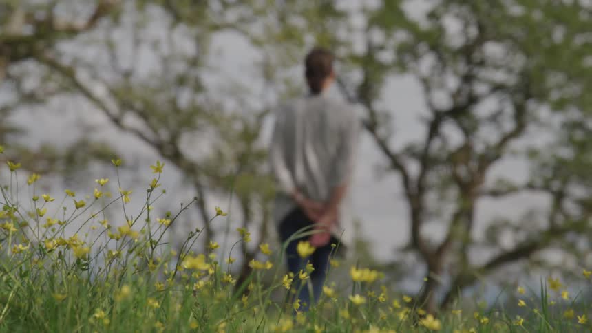 An out of focus woman contemplating alone at the park